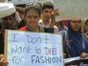 Workers in Bangladesh rallying on the one-year anniversary of the Rana Plaza factory collapse. A worker holds a sign saying "I don't want to die for fashion."