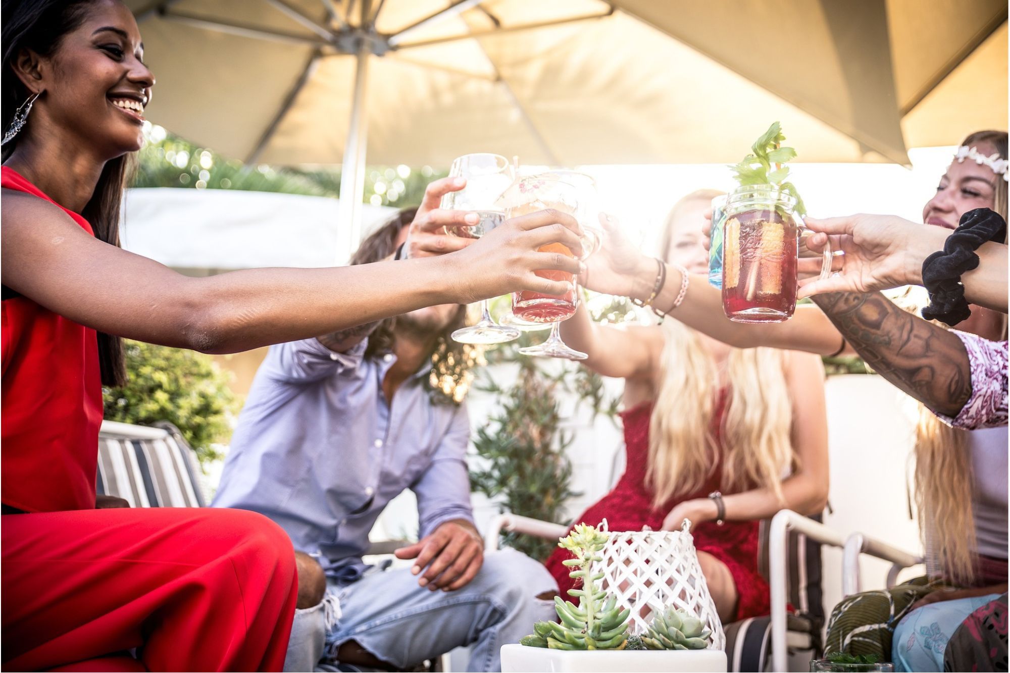 A group of friends clinking glasses to celebrate at an apartment warming party