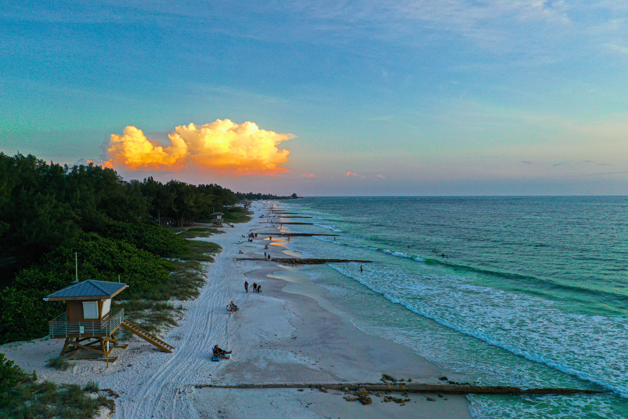 A stretch of beach with a sunset in the distance at Anna Maria Island, Florida