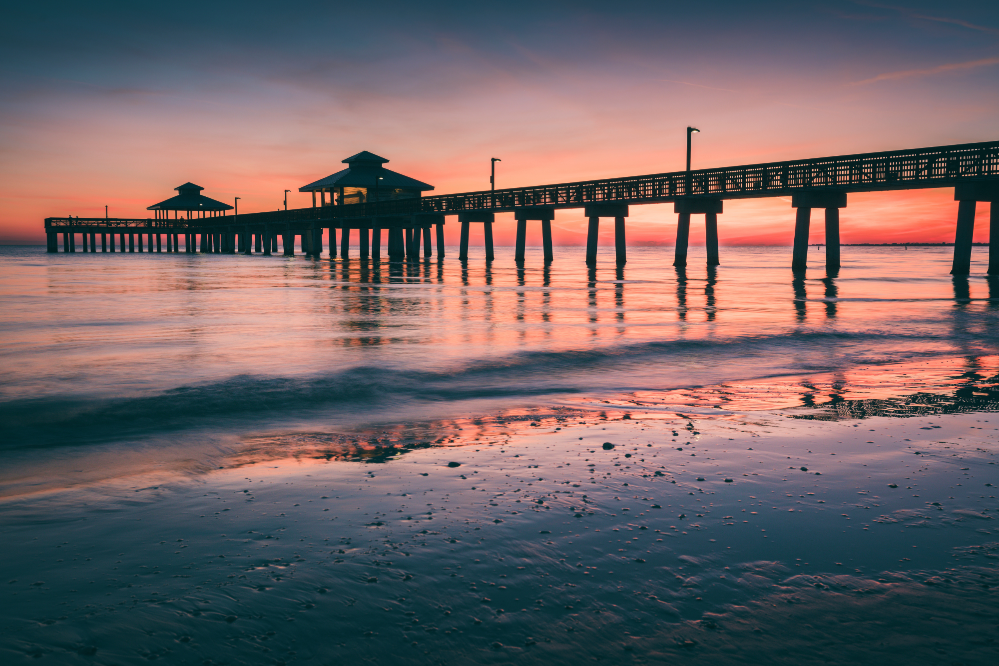 A gorgeous orange and pink sunset behind the pier on Ft Myers Beach