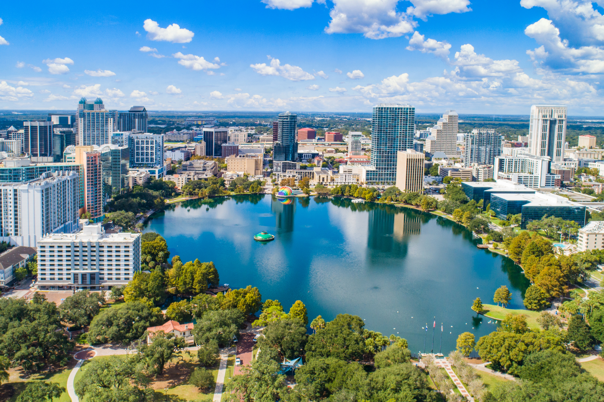 An aerial drone shot of Lake Eola in the center of Downtown Orlando, FL