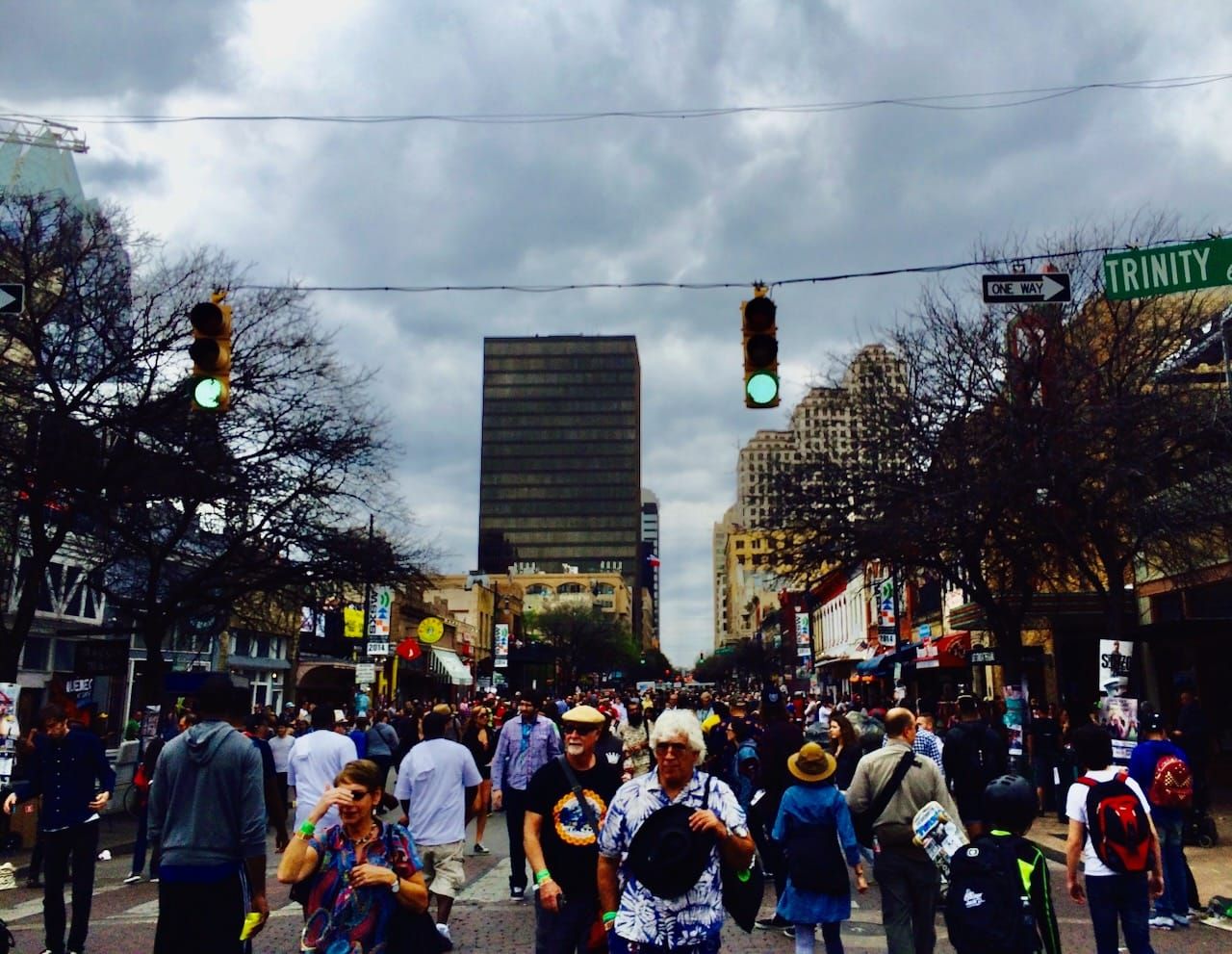 People enjoying Austin's 6th Street on a cloudy afternoon during SXSW