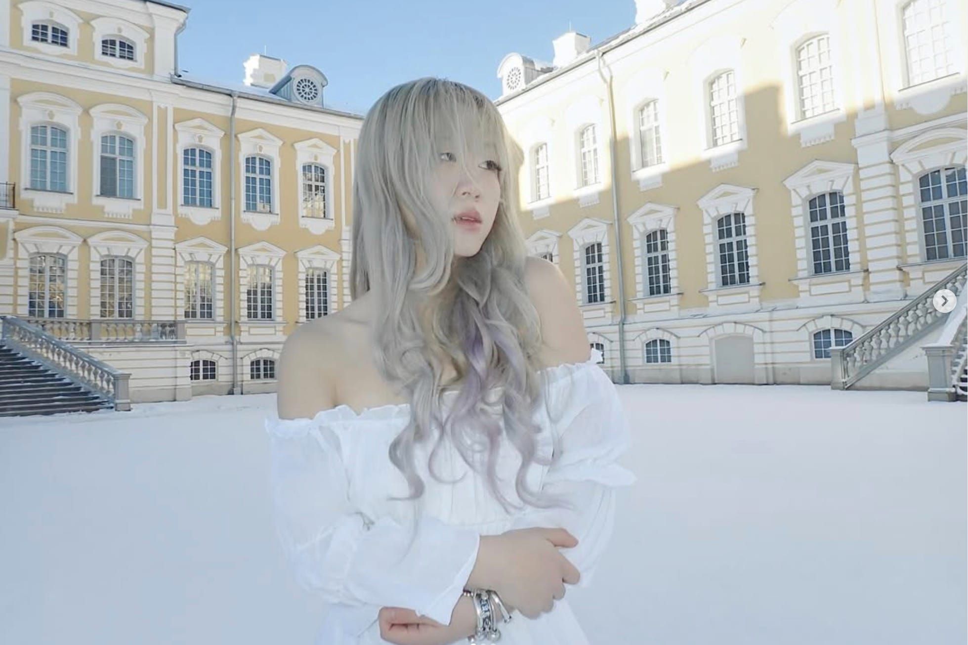 Wisp/Natalie Lu in a castle yeard covered in snow