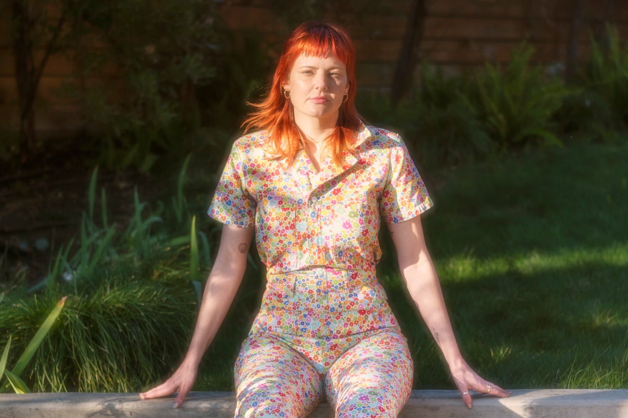 Mary-Cait Henze sitting on a wall