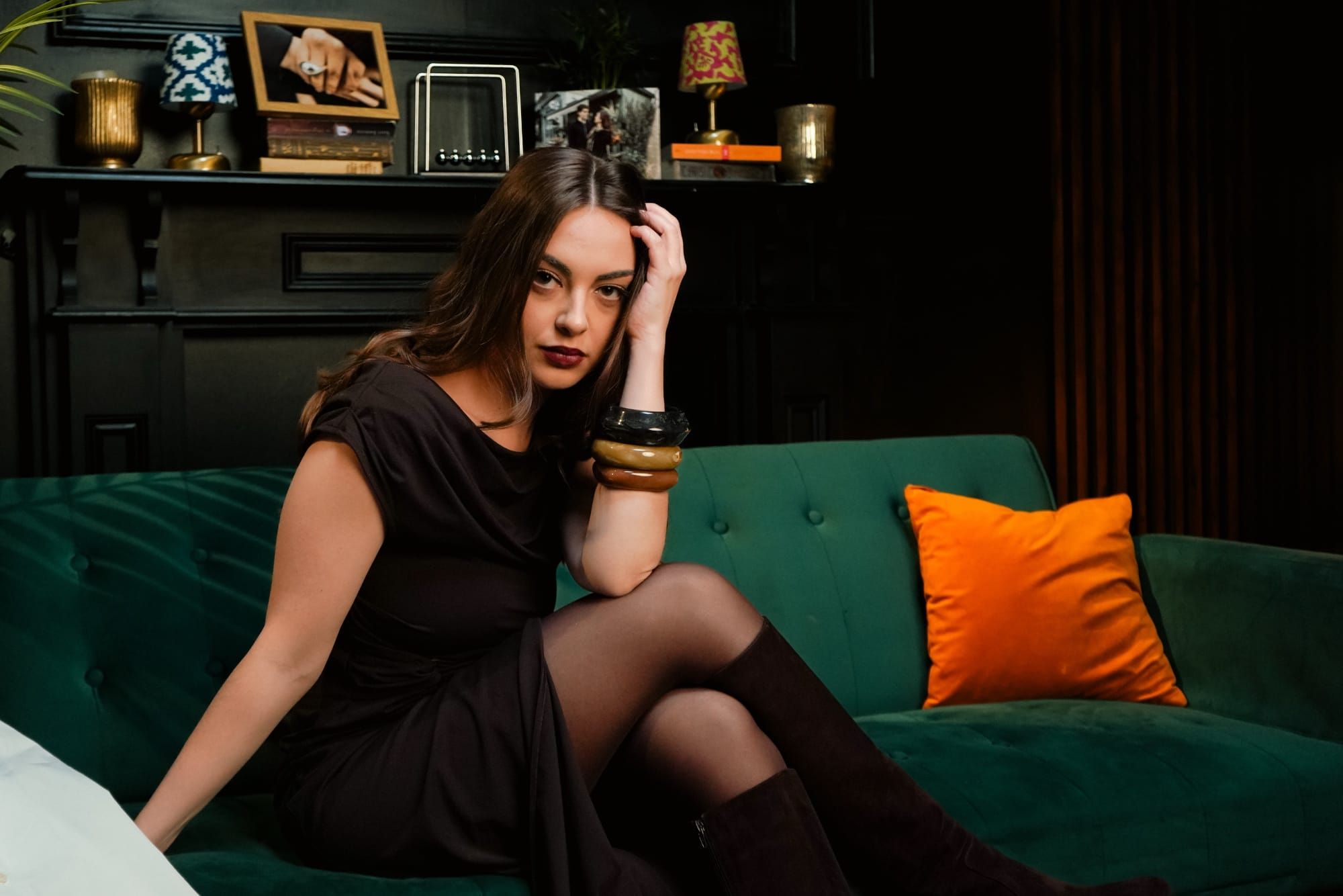 Hazel Rose sitting on a sofa in a quaint room