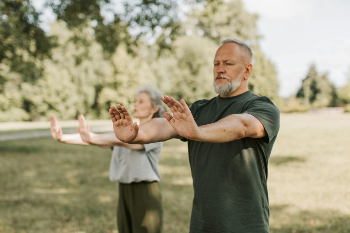 Older adults practicing Tai Chi outdoors — promoting balance and active longevity