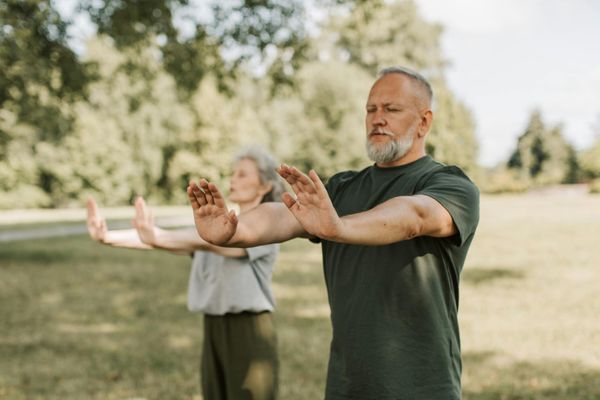 Older adults practicing Tai Chi outdoors — promoting balance and active longevity