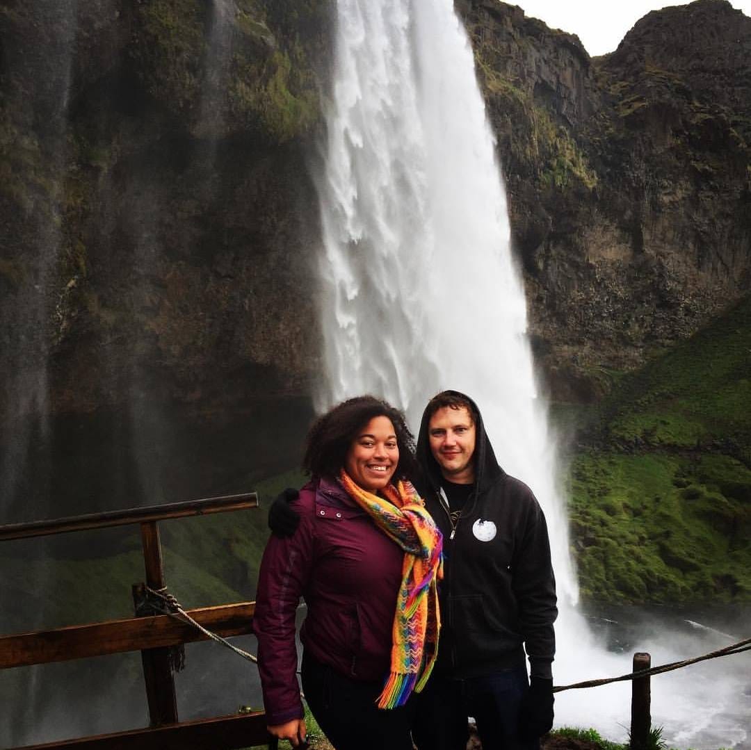 Lauren J. Mapp and her husband stand in front of a waterfall with their arms around each other