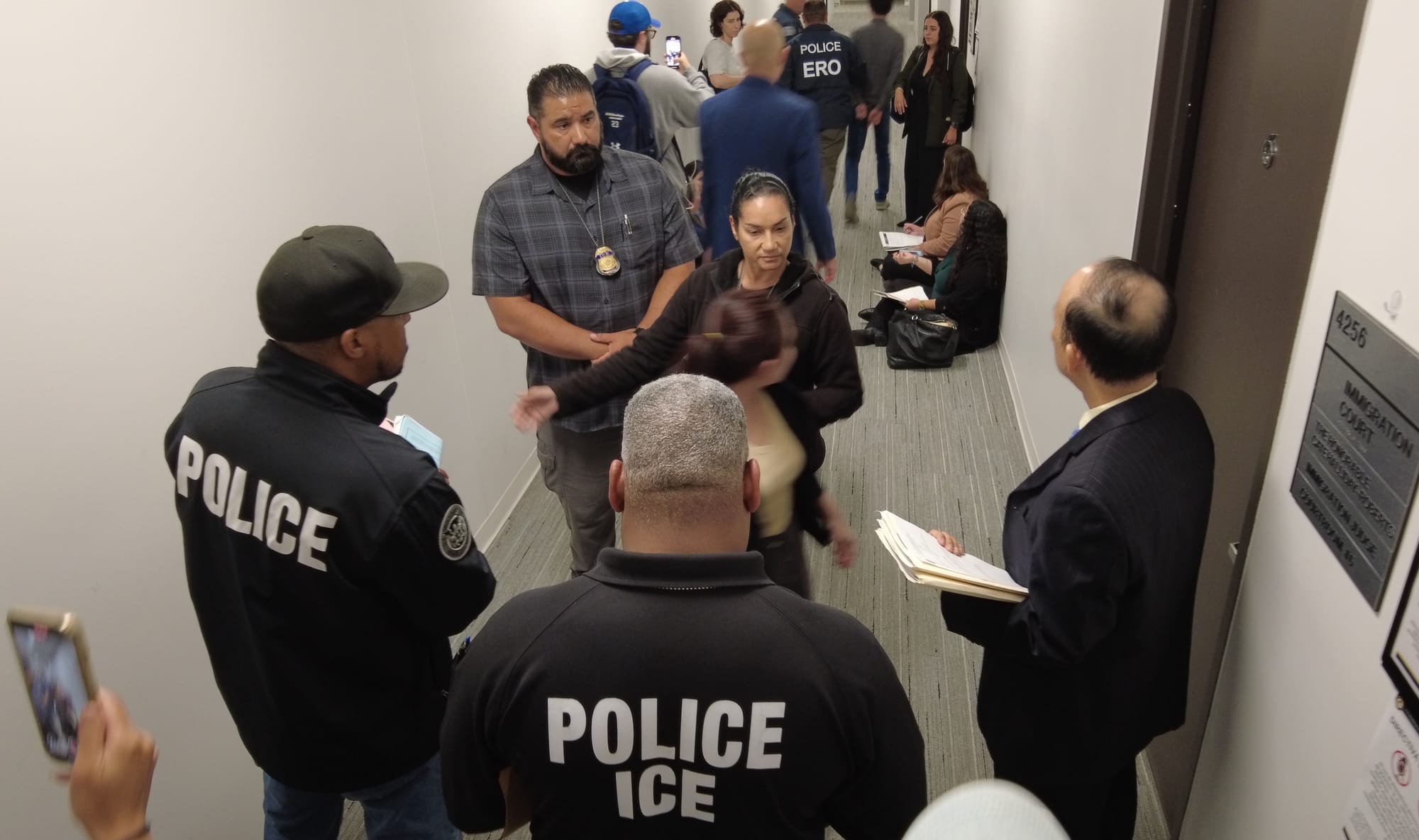 People gather and speak with one another in a hallway
