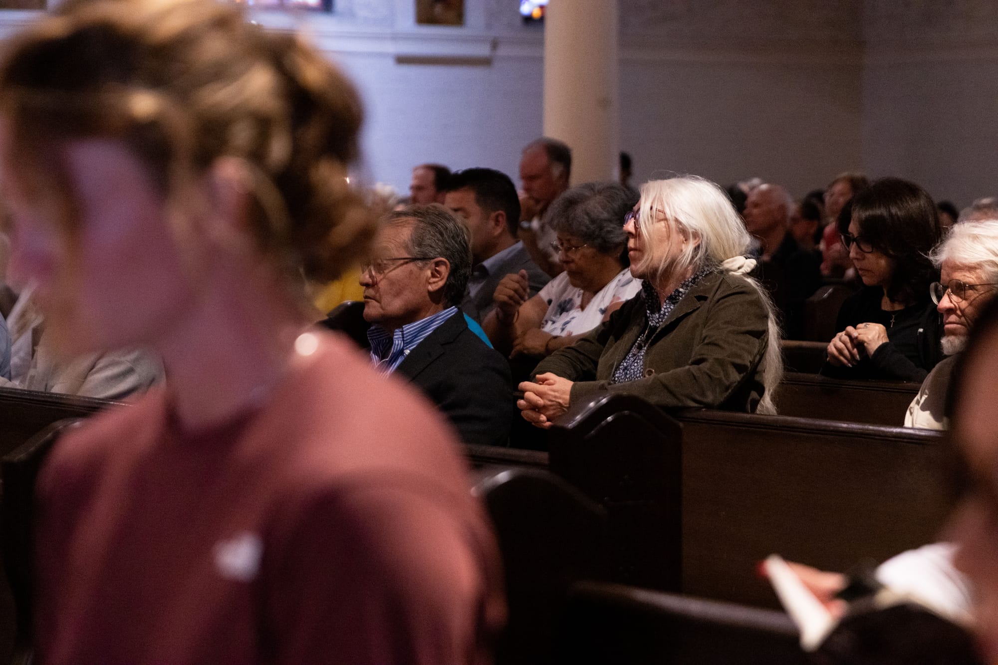 People pray in church pews