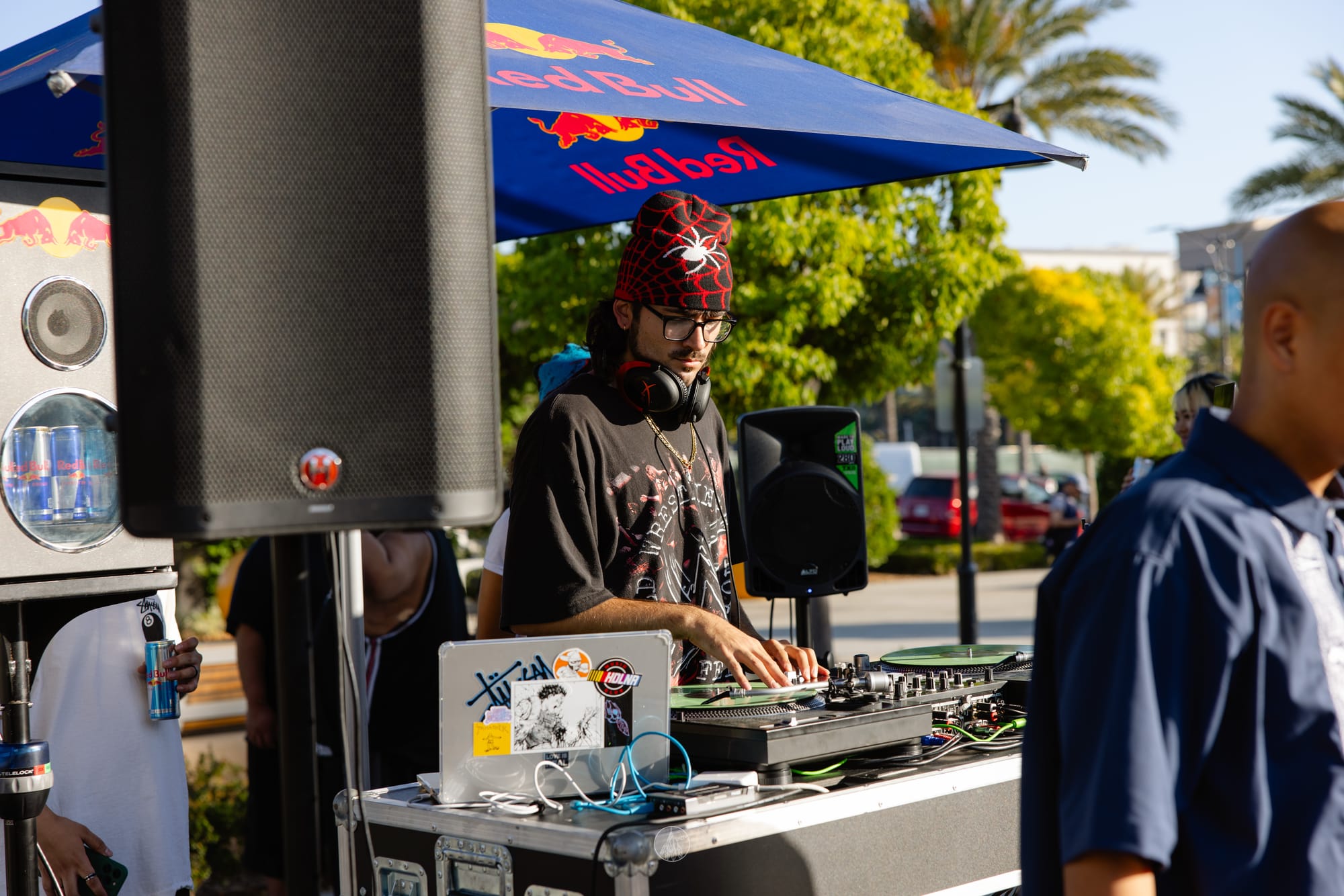 A person DJs at an outdoor event