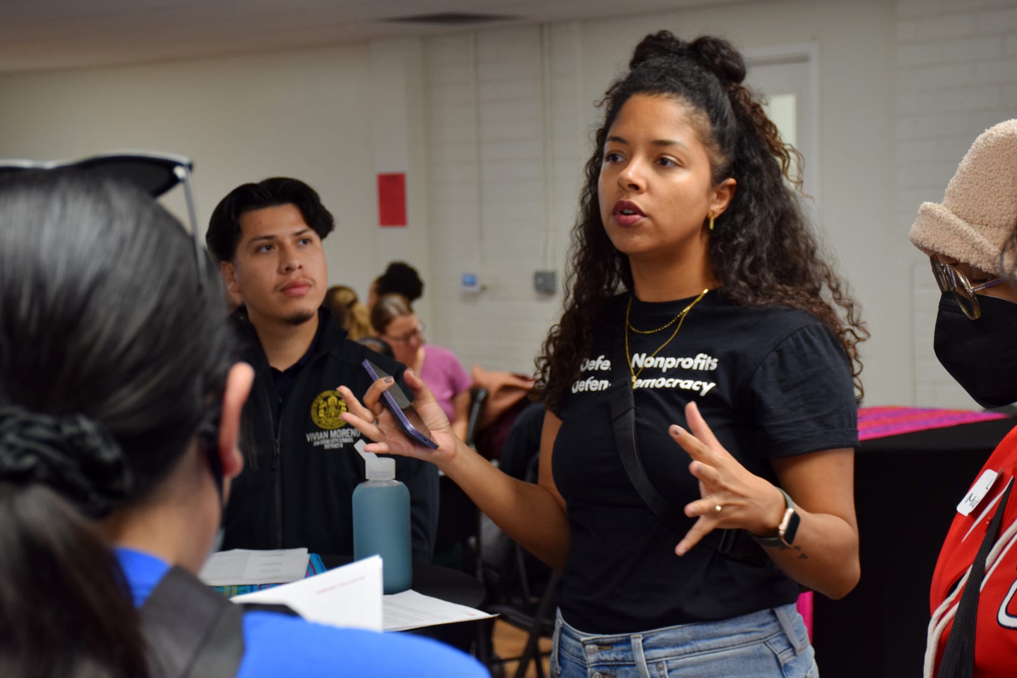 A person speaks to people during an event 