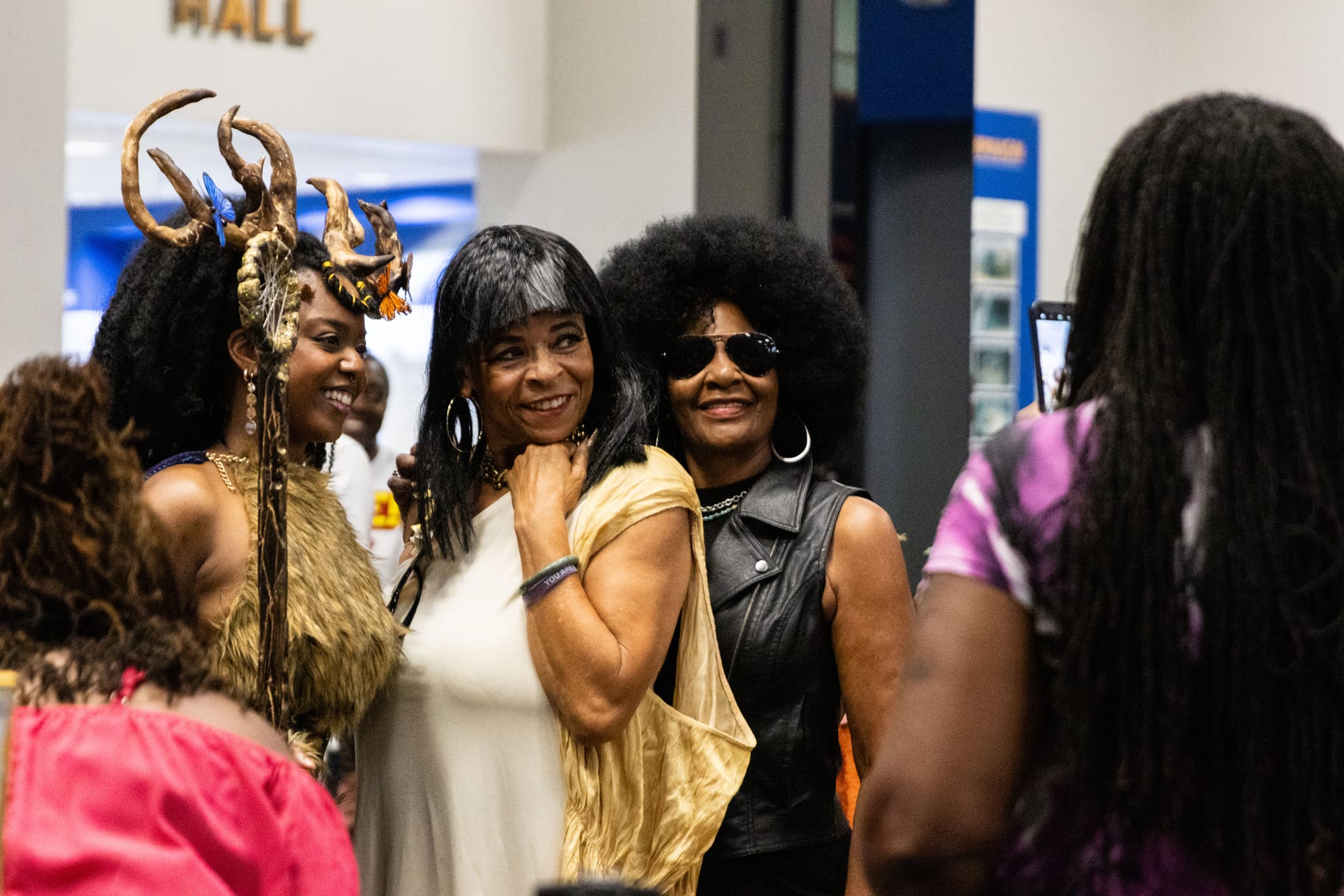 People in cosplay pose for a photograph at an event