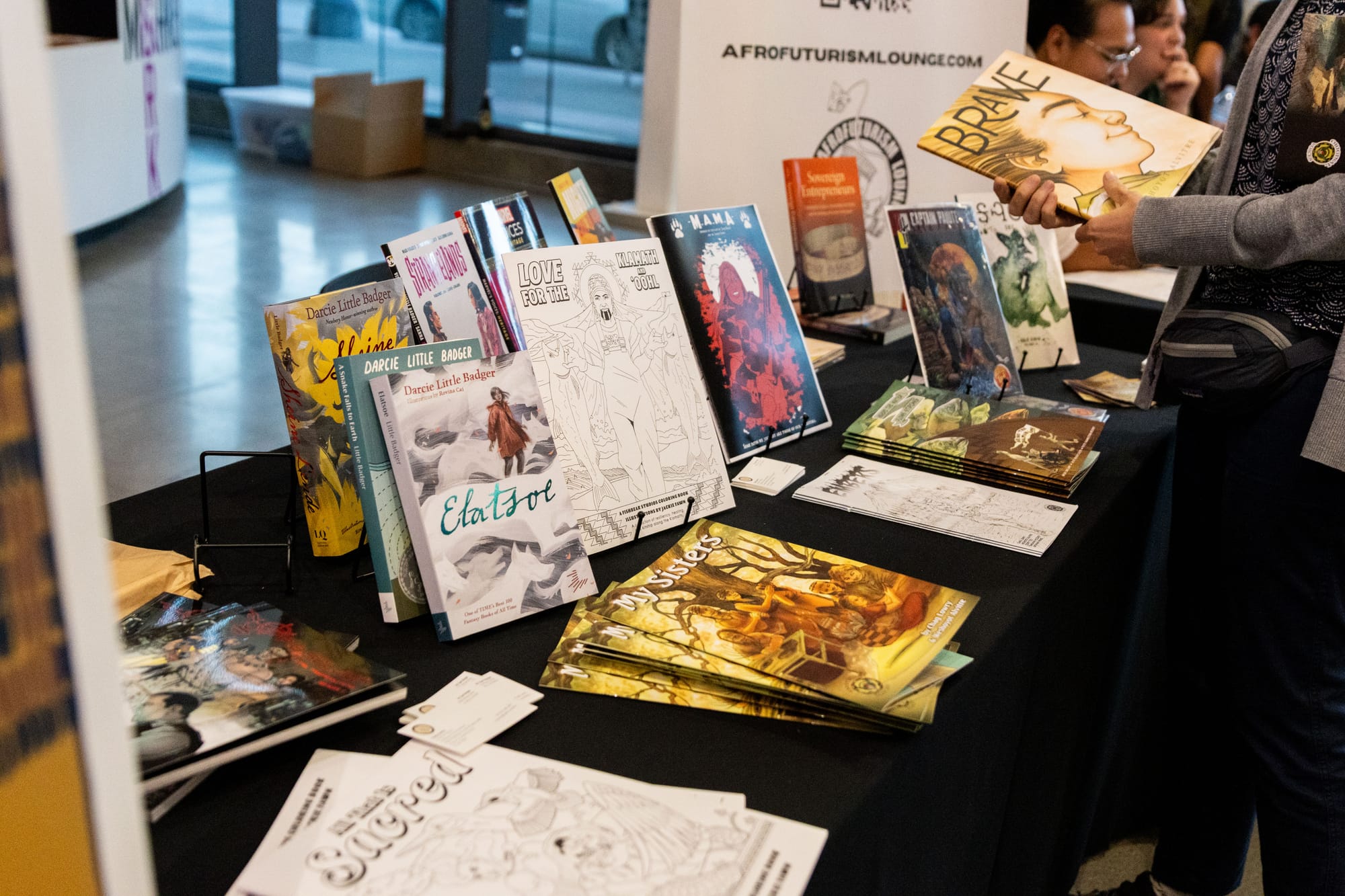 Table with a display of comic books and coloring papers