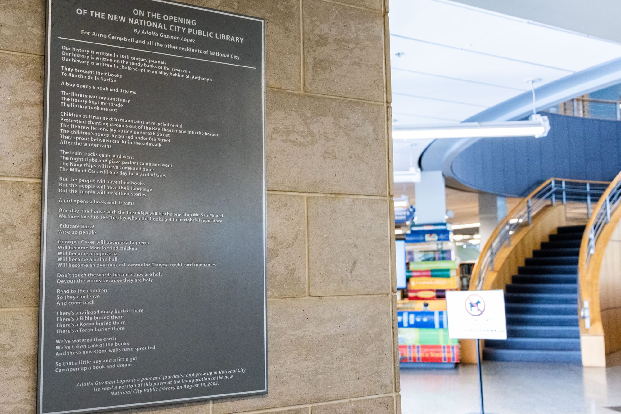 Photo of a plaque on a wall in a library