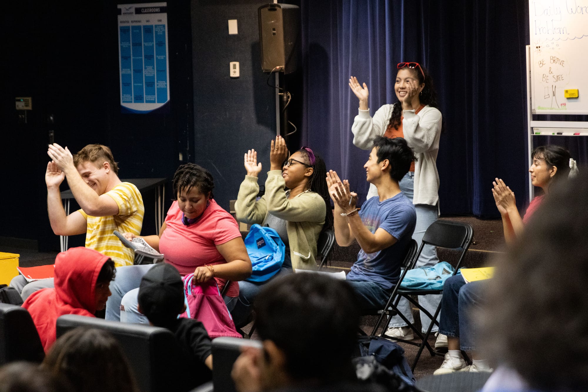 Six people clap their hands.