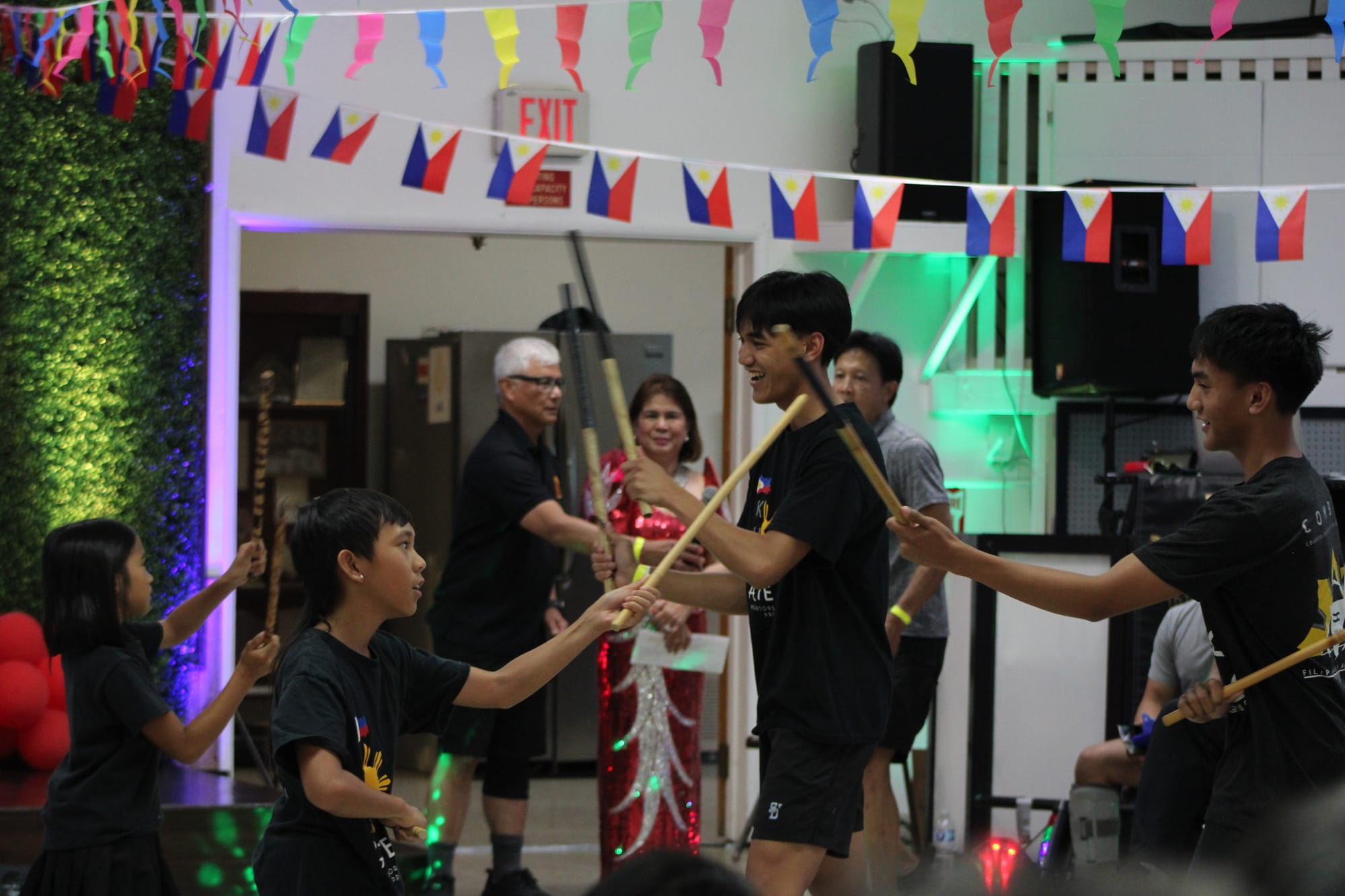A group of people demonstrate kali, an indigenous Filipino martial art that involves sticks and blades