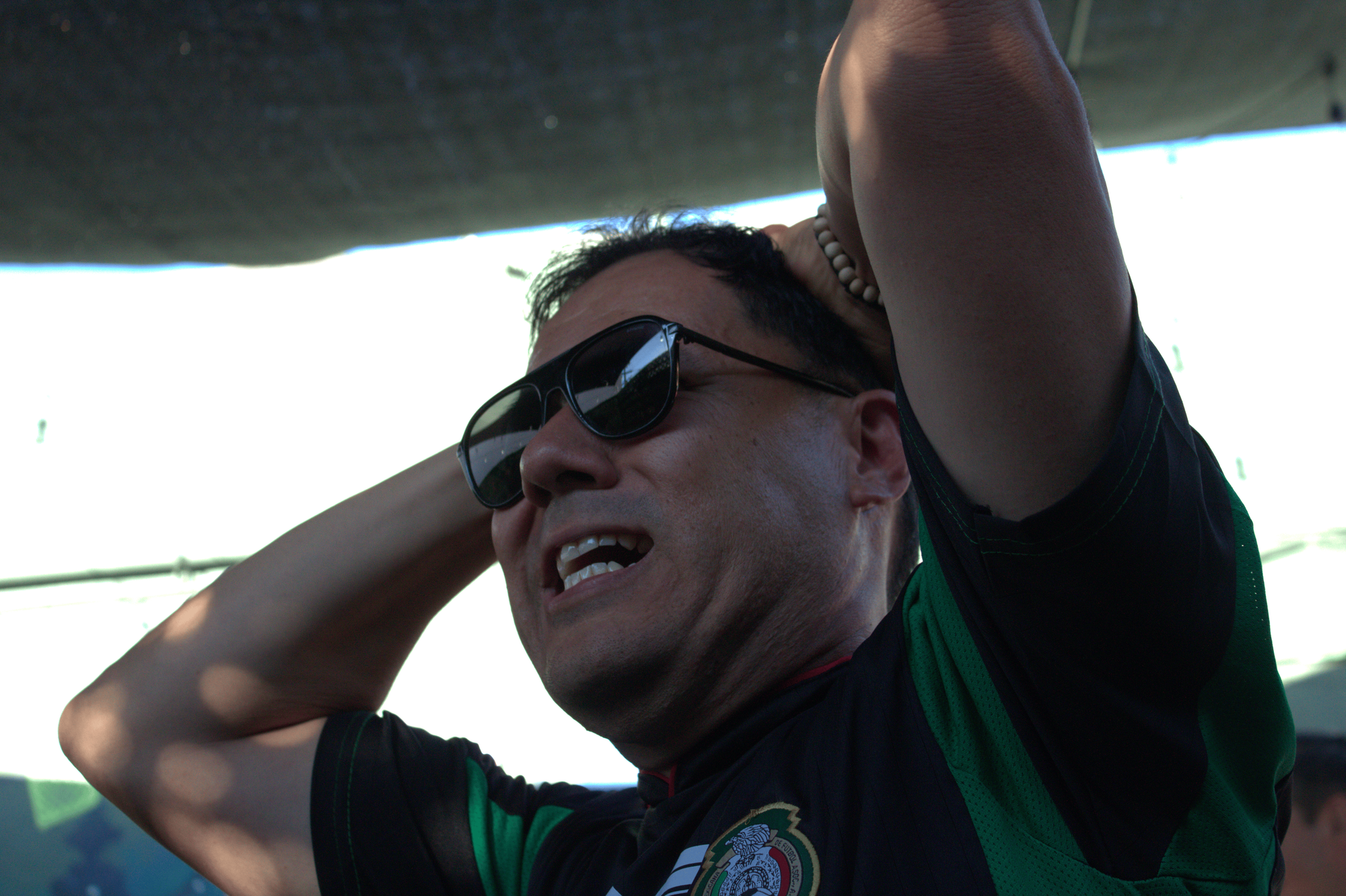 A man has his hands on his head with a negative expression on his face