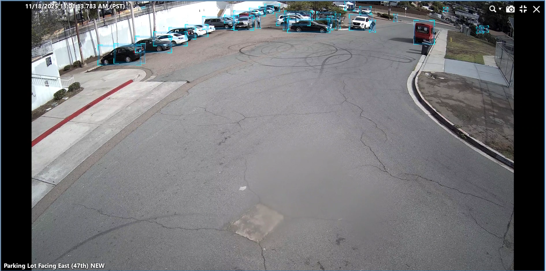 A large parking lot with few people in it