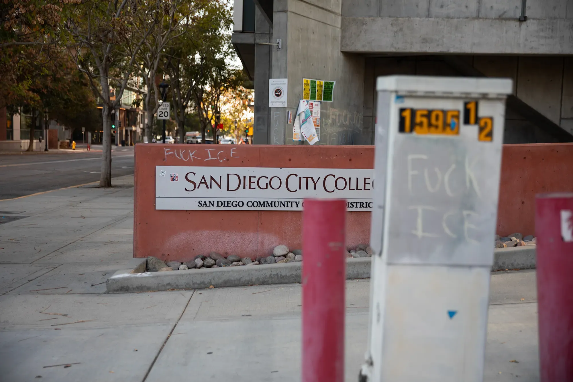 Graffiti writing that says fuck ICE on several signs on a college campus