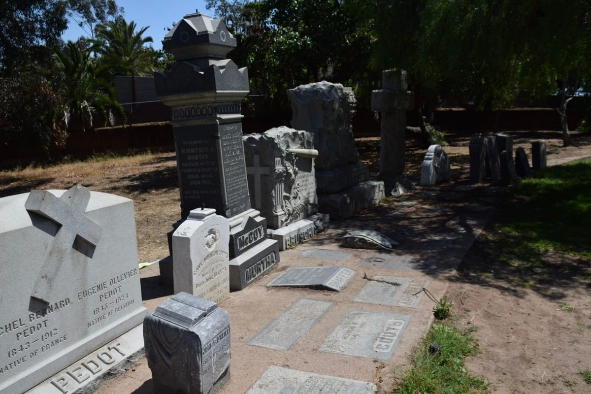 Gravestones stand in a corner 