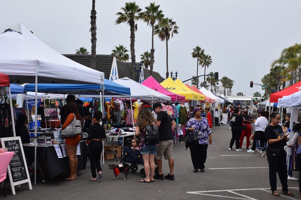 People walk around at an outdoor street fair