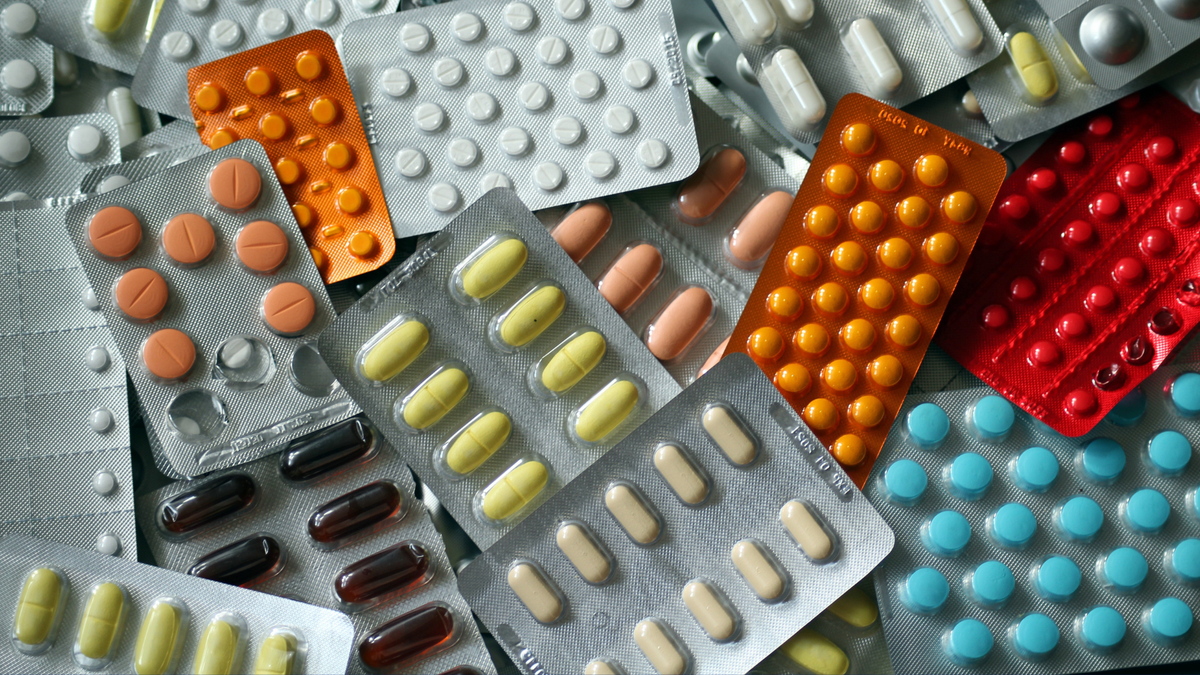 Packages of pills lie on a surface