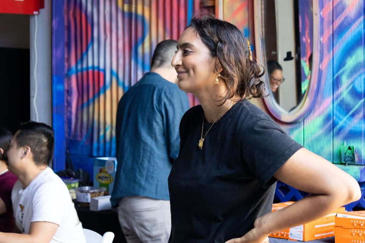 A woman poses is seen with her hands on hips at an event 