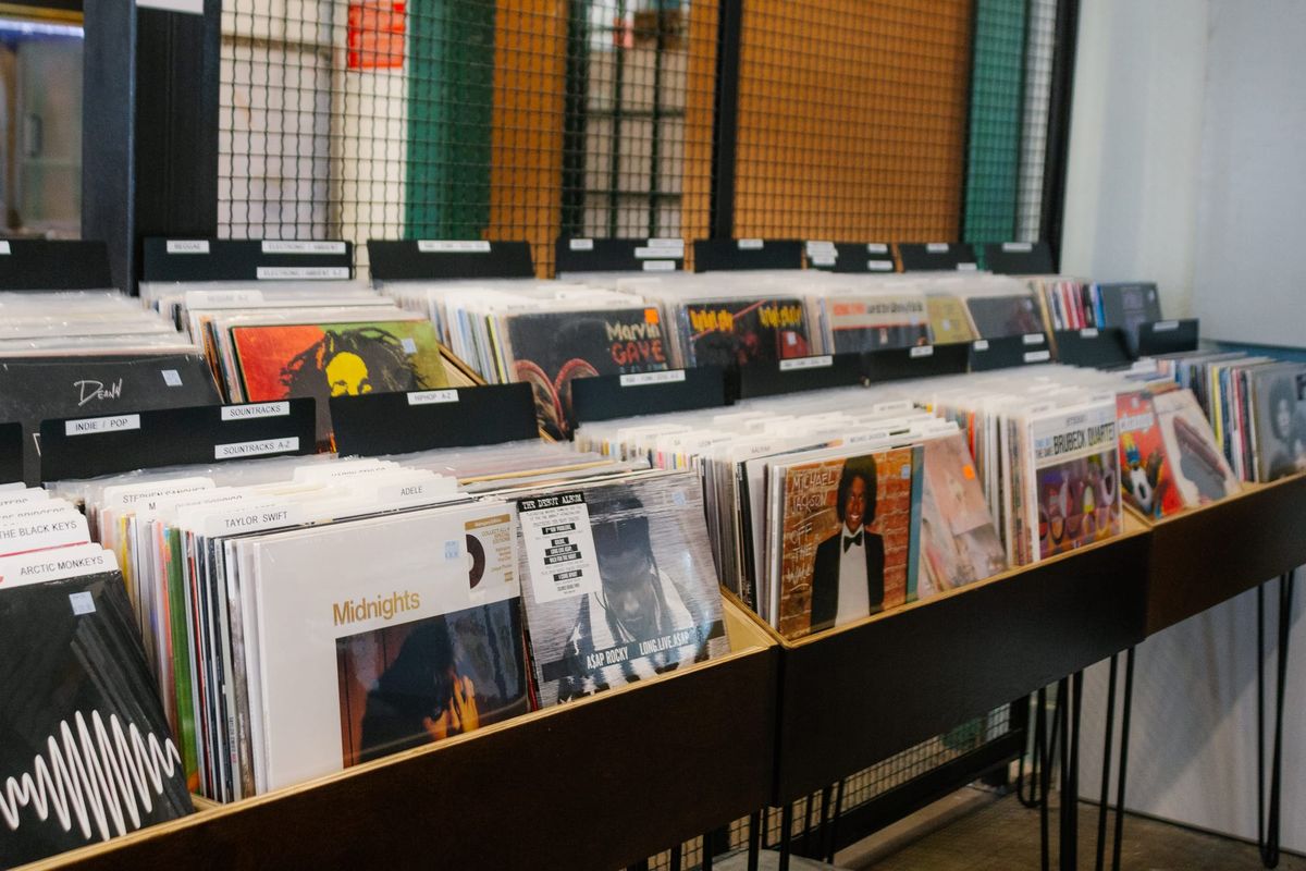 Two rows of vinyl records in their album covers for sale in a shop
