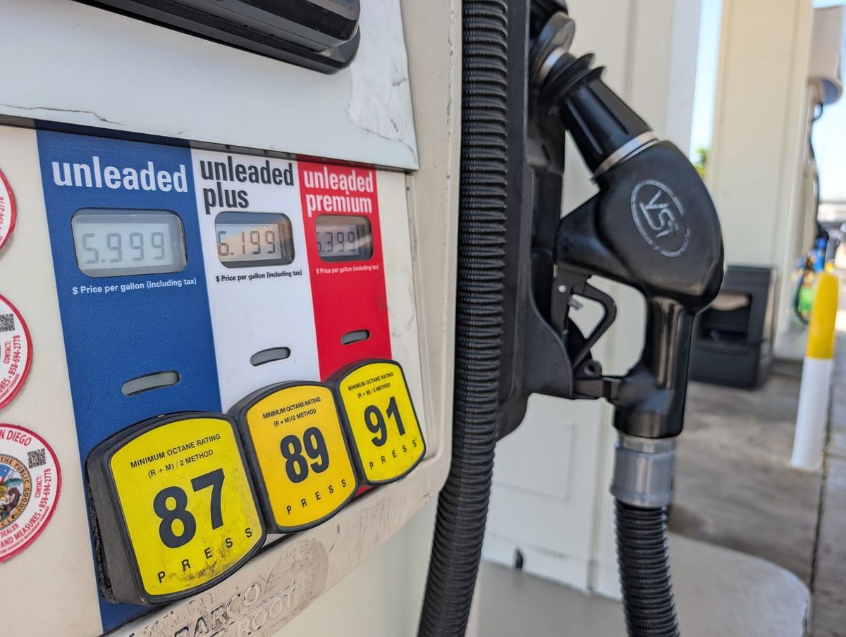 a gas pump with unleaded, unleaded plus and unleaded premium fuel in blue white a and red
