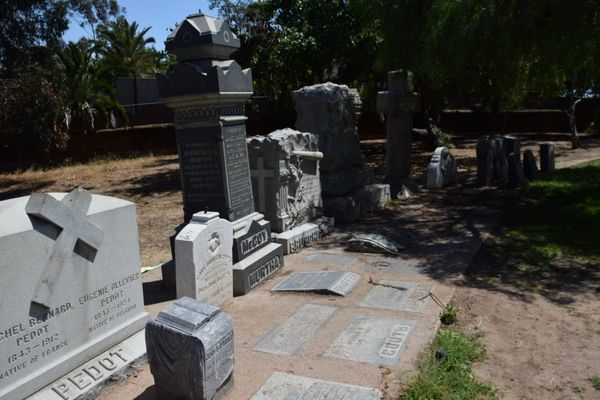 Gravestones stand in a corner 