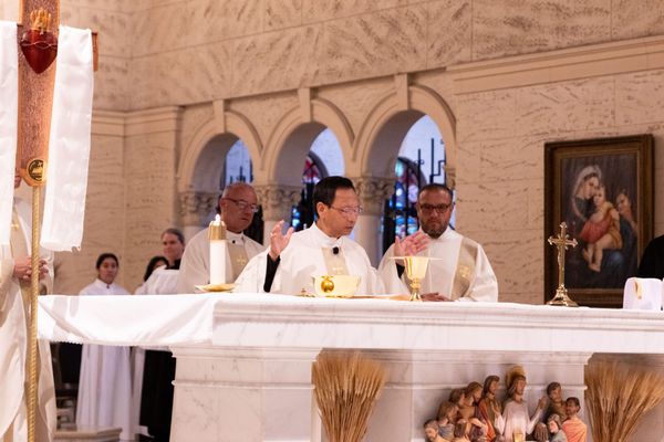 A group of religious leaders stand in a church during Mass