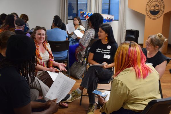 People sit in groups talking during an event