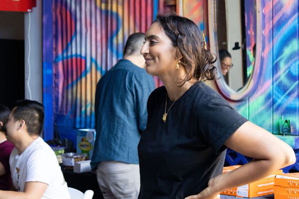 A woman poses is seen with her hands on hips at an event 