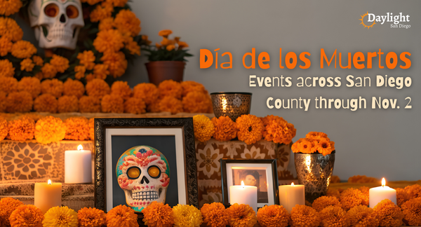 Image of a Día de los Muertos altar with marigolds and candles. Words on the image say "Día de los Muertos: Events across San Diego County through Nov. 2"