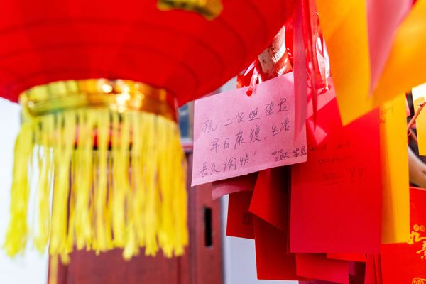 Close up of red paper lanterns and messages written in Chinese