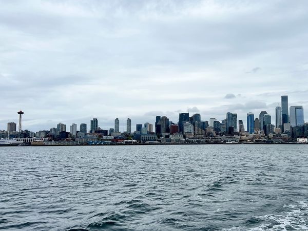 Picture of a city skyline over a body of water with the space needle to the left.