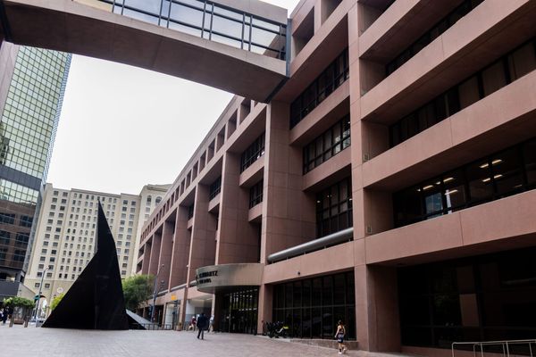 A brown building with a brick plaza in front