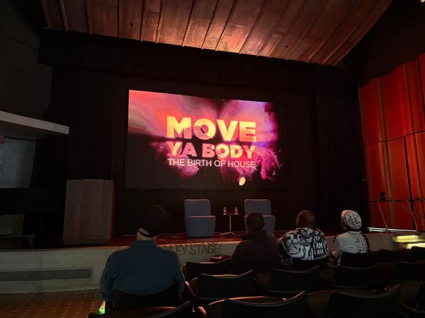 A theater plays a film and the screen reads “Move Ya Body: The Birth of House.”