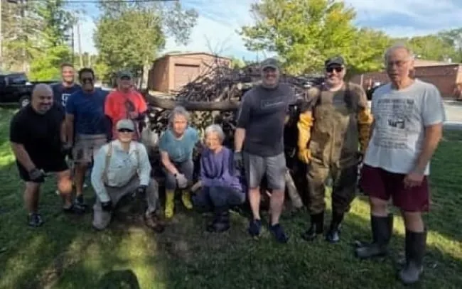 Winchester volunteers clear debris blocking Wedge Pond water flow