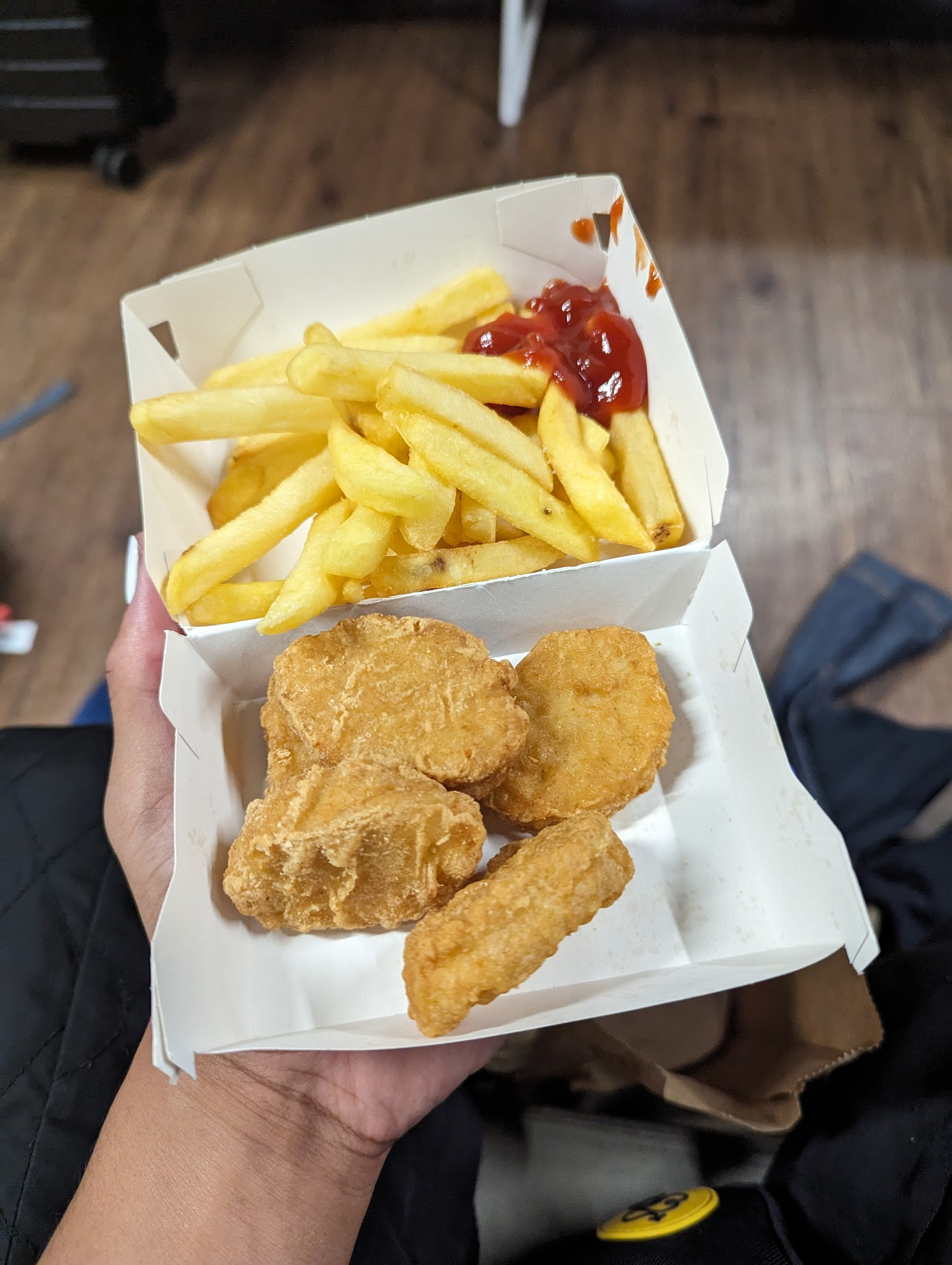 a photo of 4 chicken nuggets and fries