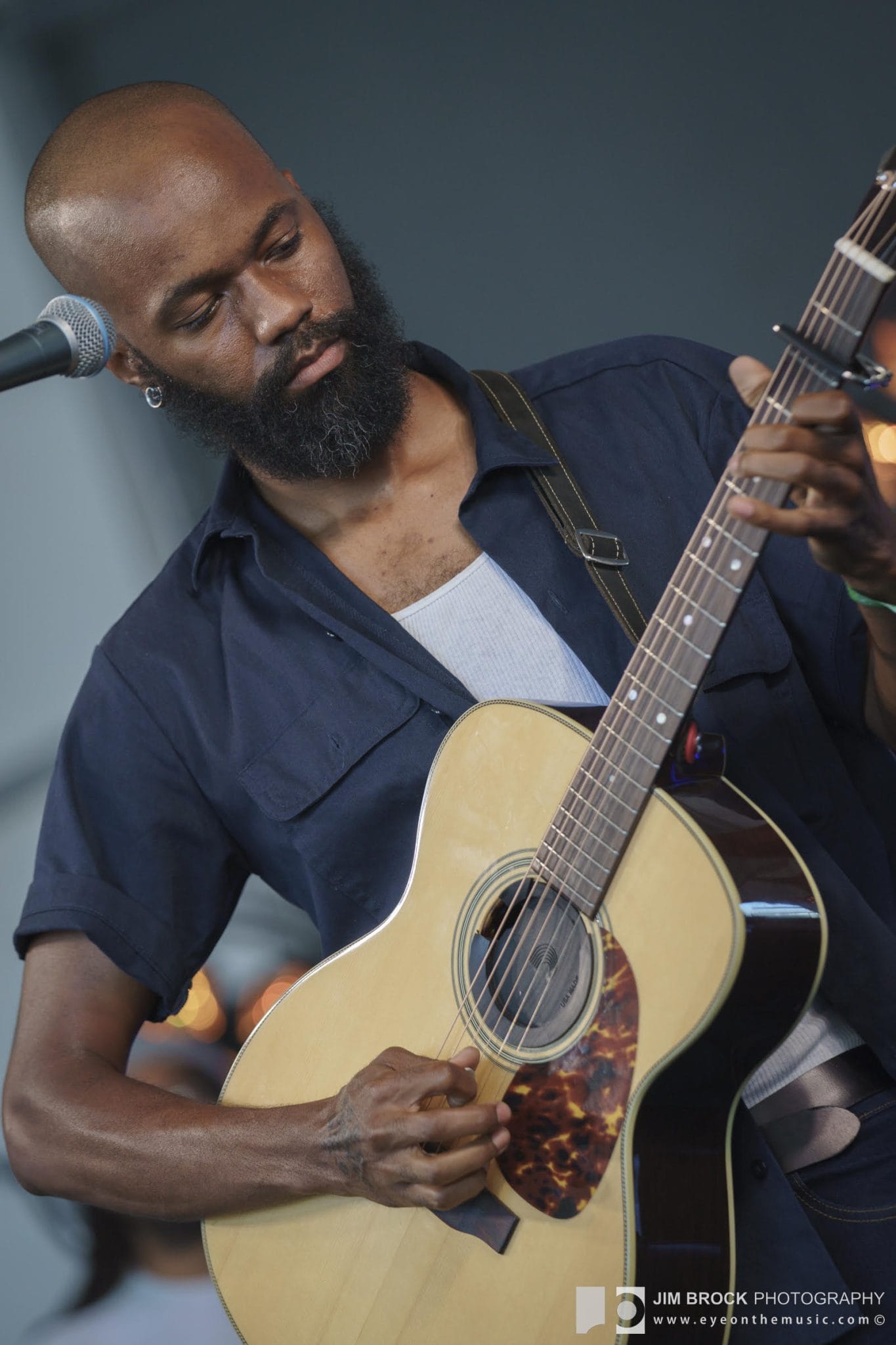 Buffalo Nichols plays an acoustic guitar at the Black Opry Revue set at the 2022 Newport Folk Festival.