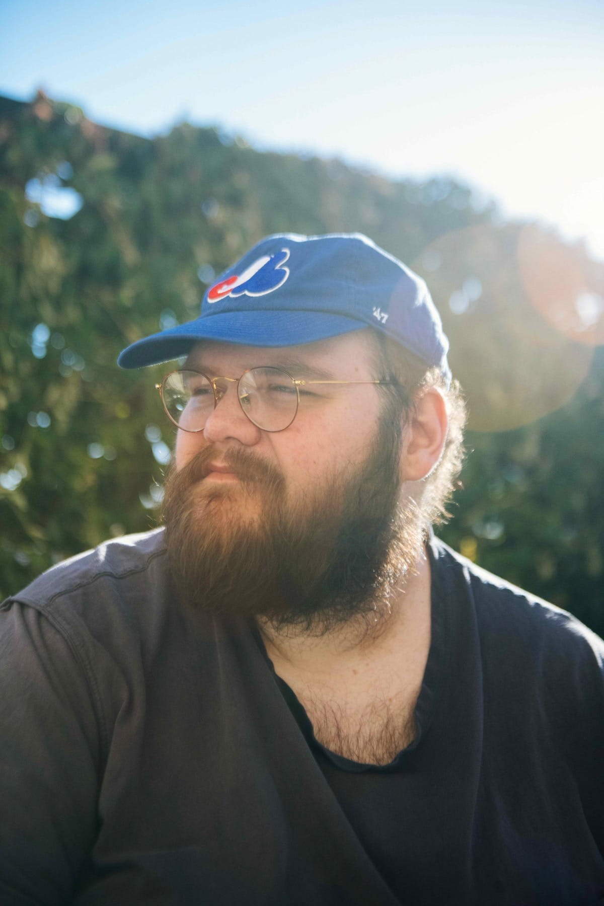 John Moreland outside, wearing a baseball cap