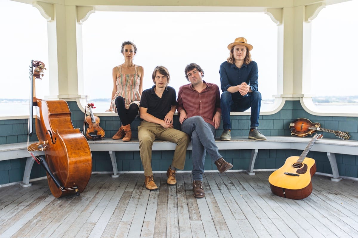 Hawktail band portrait with instruments on a bench