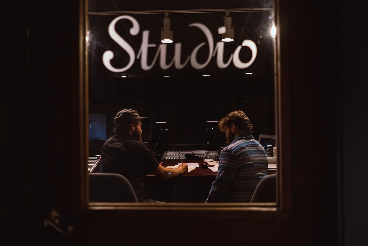 Twin brothers David Moss and Adam Moss behind the board in the studio