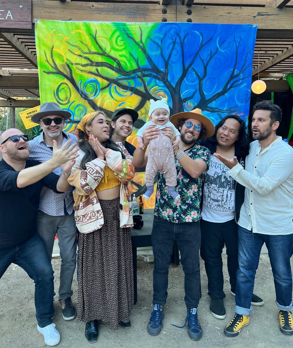 The band Dustbowl Revival gathers around baby July