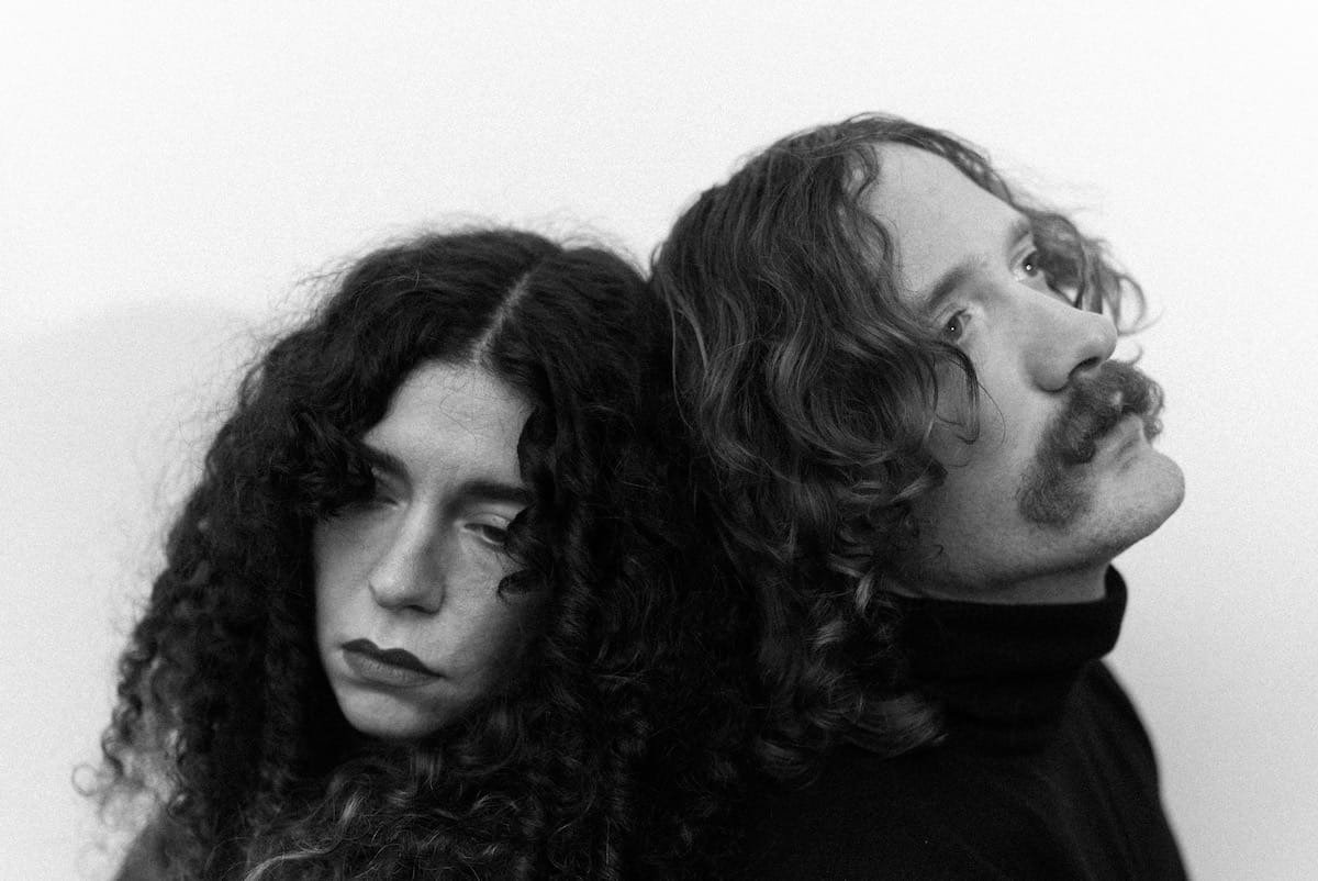 A black and white portrait of the two leads of Honey Harper