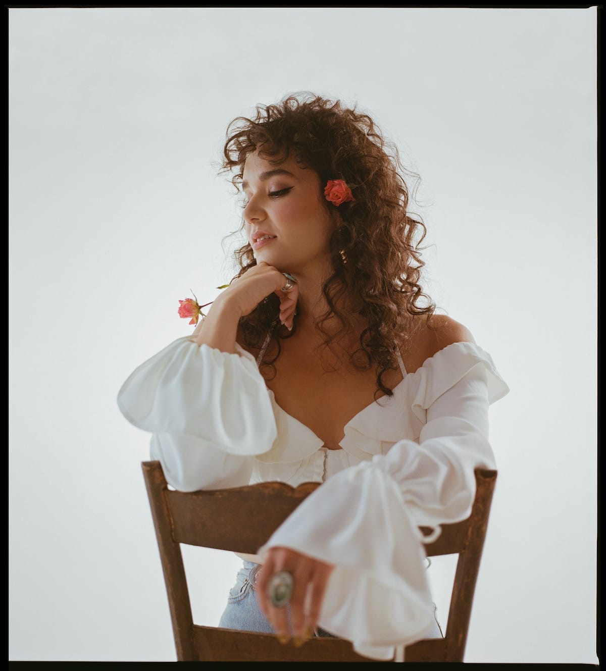 Emily Nenni seated backward on a wooden chair