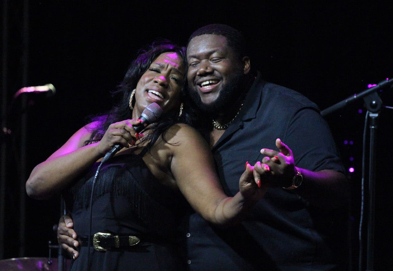 The War and Treaty embrace while singing on stage