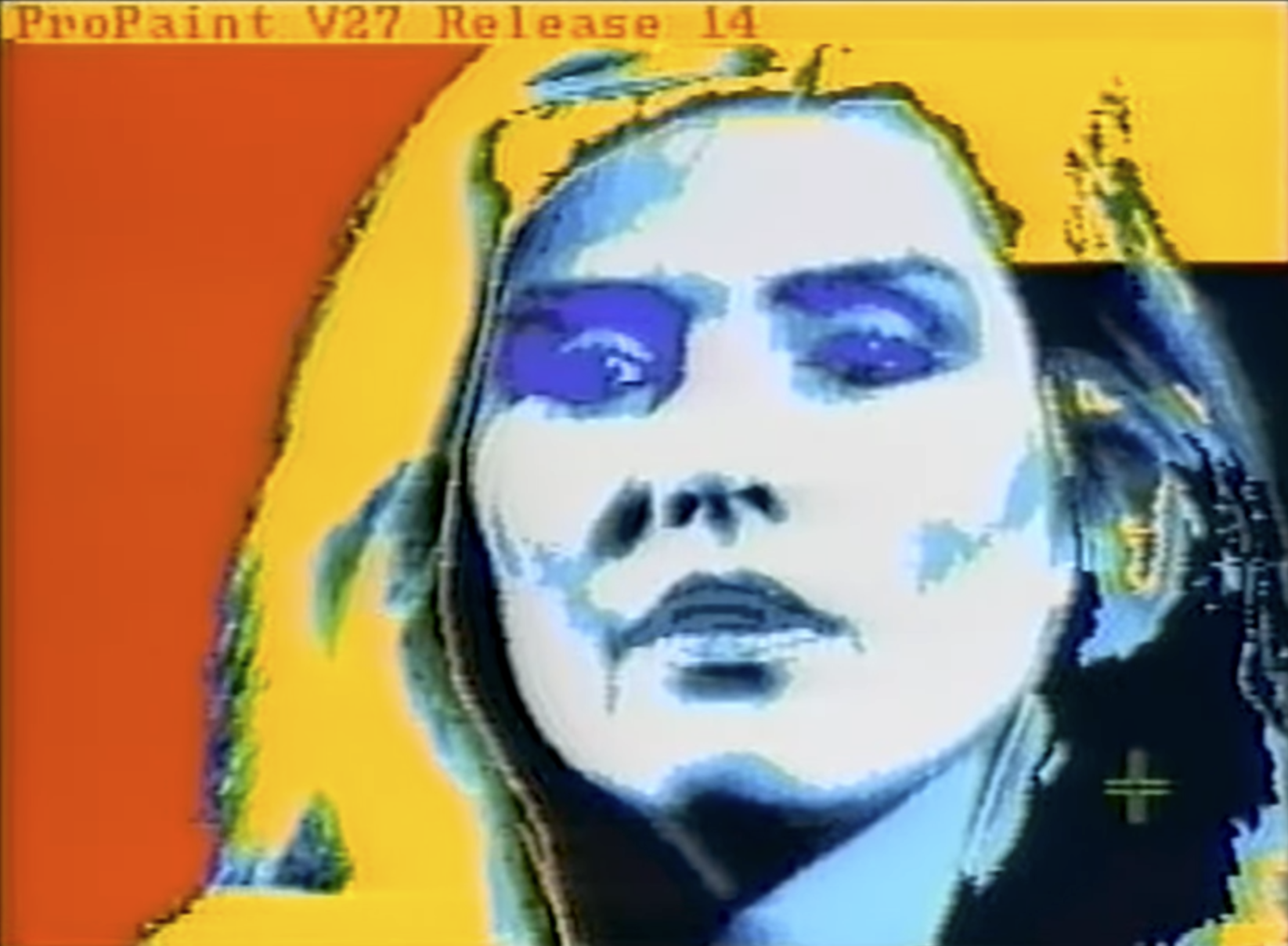 Video frame grab of Debbie Harry in ProPaint V24 Release 14 on a Commodore Amiga. Her face has a blue-white solarized look, and her hair is mid-flood-fill to bright yellow.